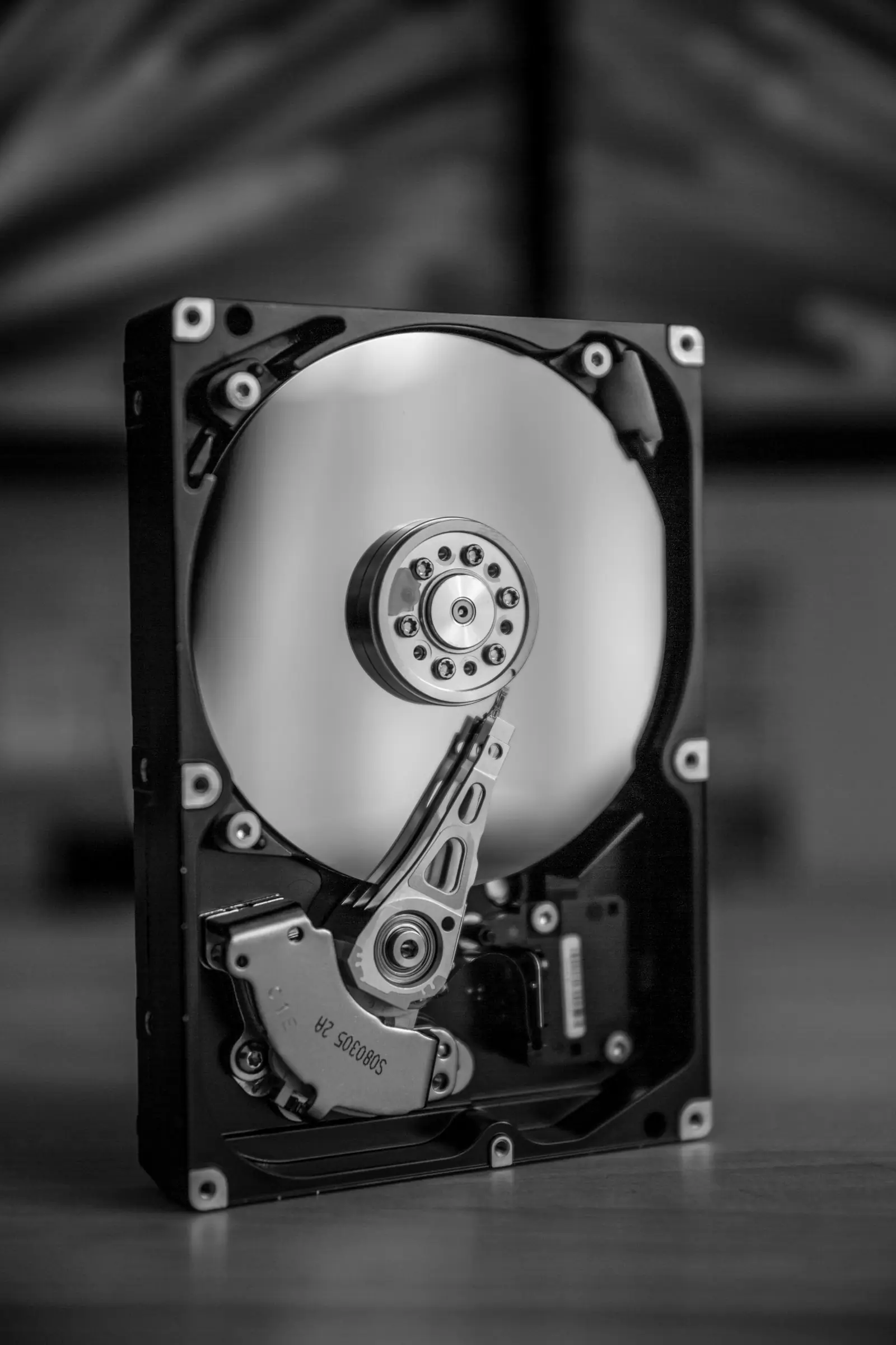 The platter and read arm of an opened hard drive