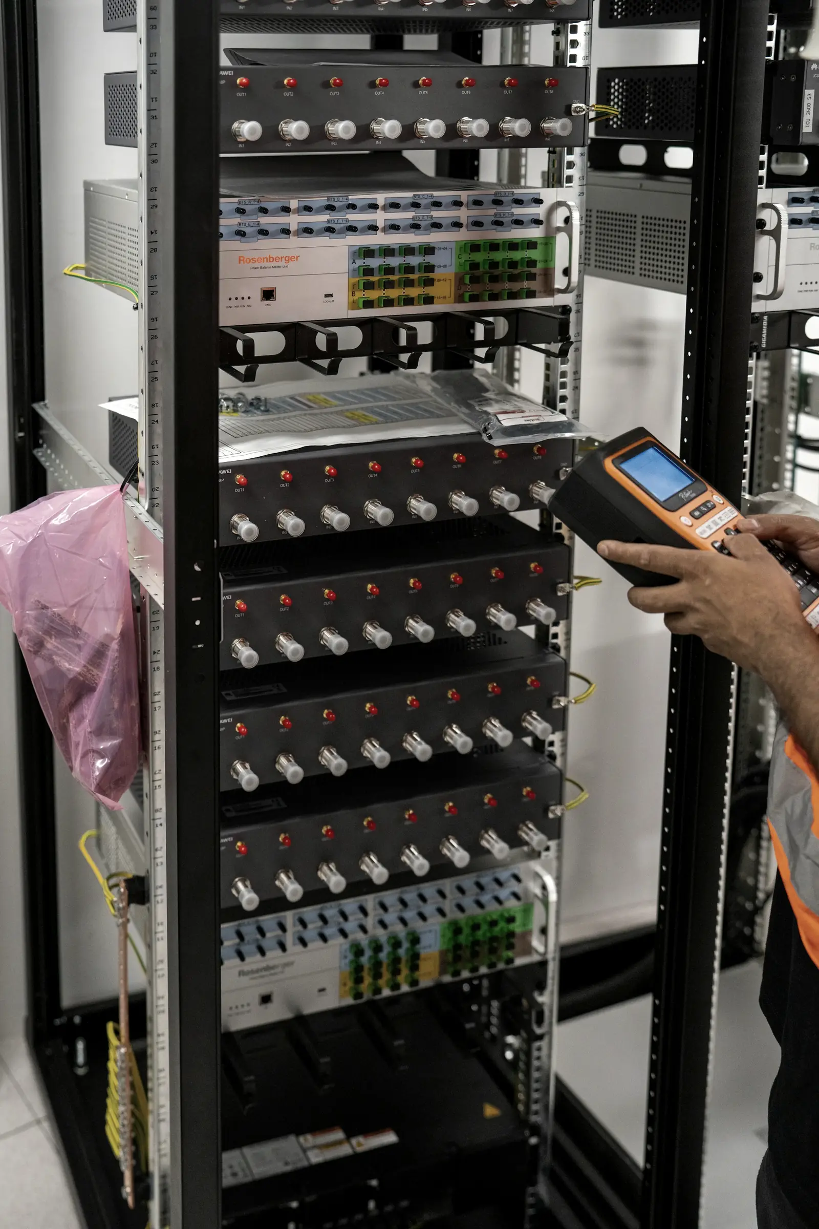 A technician scanning equipment serials in a server rack