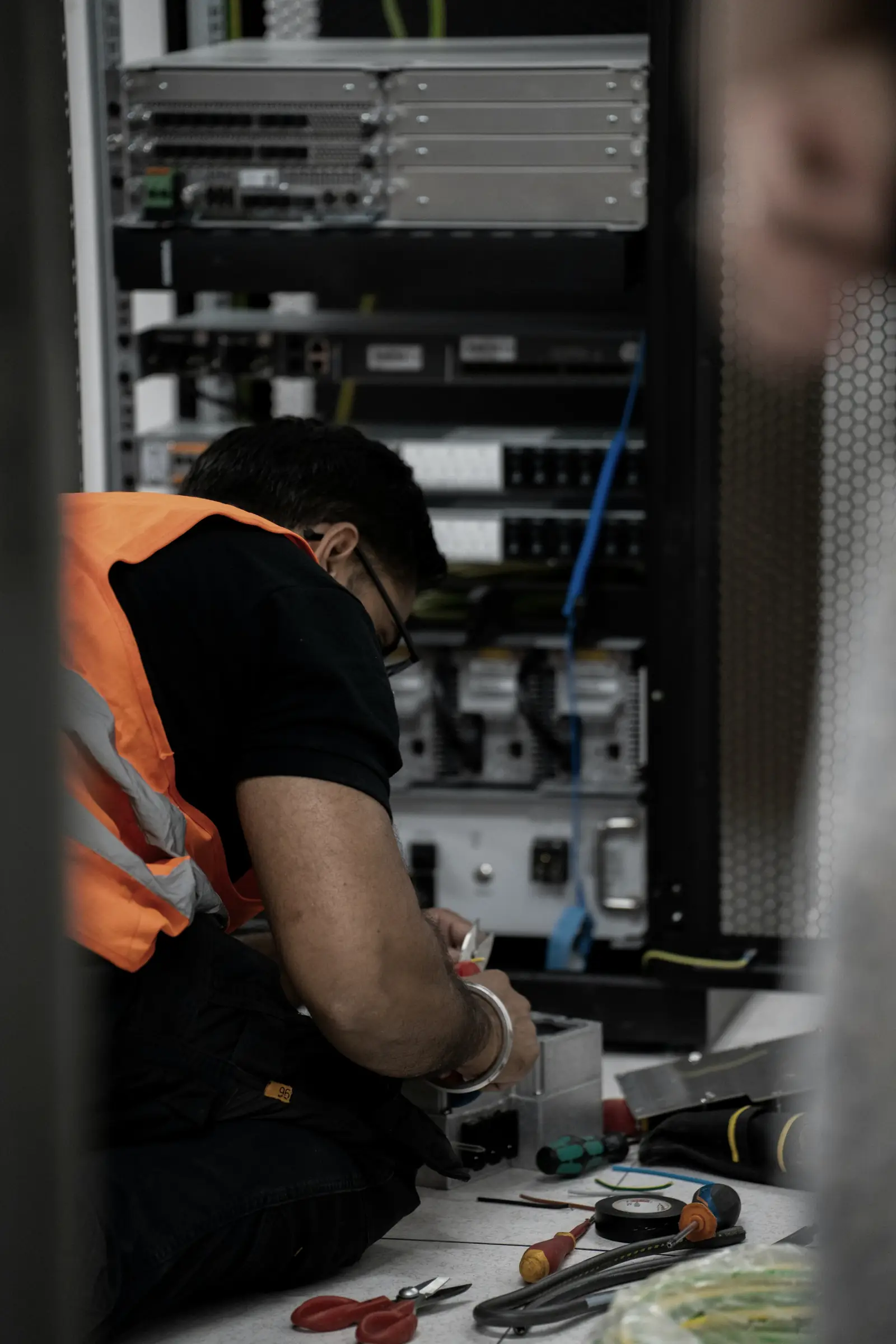 A technician working on rack-mounted equipment