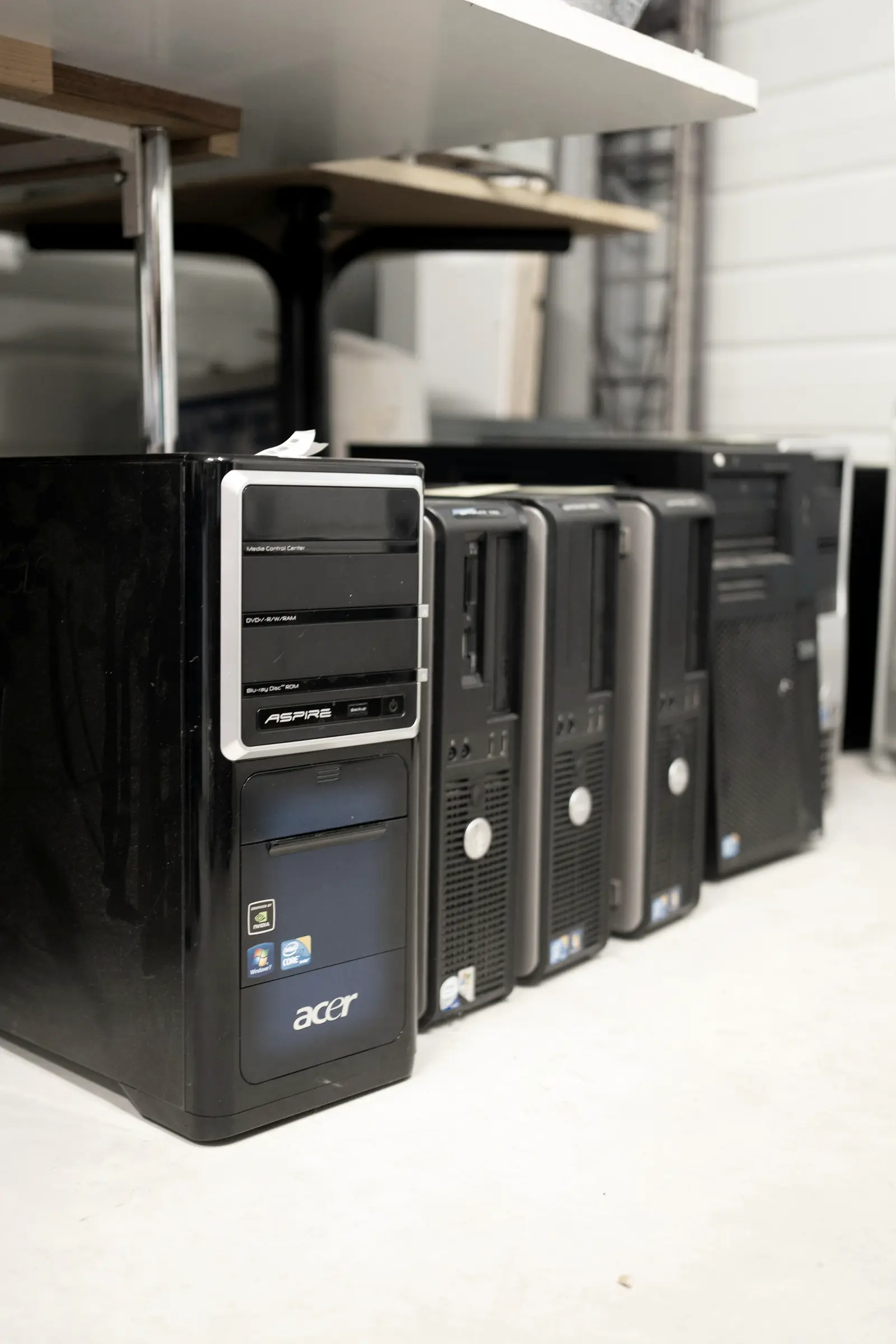 A row of retired desktop towers staged for processing